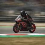 An Italian rider on his MotoGP bike speeds through a corner at the Misano circuit during Friday practice.