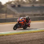 South African rider Brad Binder walking away from his Red Bull KTM bike in the pit lane, symbolising his departure from the team.