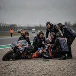 MotoGP rider Marco Bezzecchi receives medical attention in the gravel trap at Sachsenring following his qualifying crash.