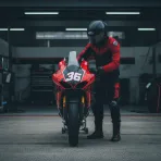 An empty Honda HRC pit garage with a mechanic preparing a bike, symbolising Joan Mir's absence and the preparation for his substitute.