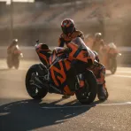 A red Ducati helmet and a black Aprilia helmet positioned back-to-back, representing the major rider swap.