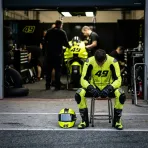 Illustration for our rider injury story: a rider resting in the pit garage, looking pensive.