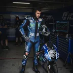MotoGP rider Fabio Quartararo studies data on a monitor inside the Yamaha team garage.