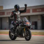 Marco Bezzecchi celebrates taking pole position for the San Marino Grand Prix at the Misano circuit.