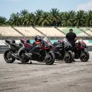 Illustration for our Indonesian Grand Prix story: four racing motorcycles parked in a row in the pit lane enclosure.