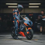 Pol Espargaró's helmet rests on the fuel tank of the Tech3 bike inside the team garage ahead of the British Grand Prix.