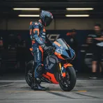 Pol Espargaró's helmet rests on the fuel tank of the Tech3 bike inside the team garage ahead of the British Grand Prix.