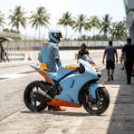 Illustration for our Indonesian GP Practice story: a racing motorbike resting on the pit lane under bright tropical sunshine.