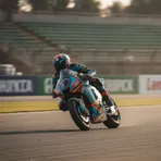 A composite image showing the distinct pit garage setups for Fabio Di Giannantonio's MotoGP bike and Ai Ogura's MotoGP bike.