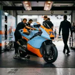 Illustration for our Trackhouse Racing livery story: a racing motorcycle parked under garage spotlights.